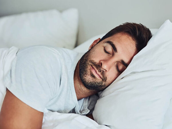 Man with beard sleeping in bed